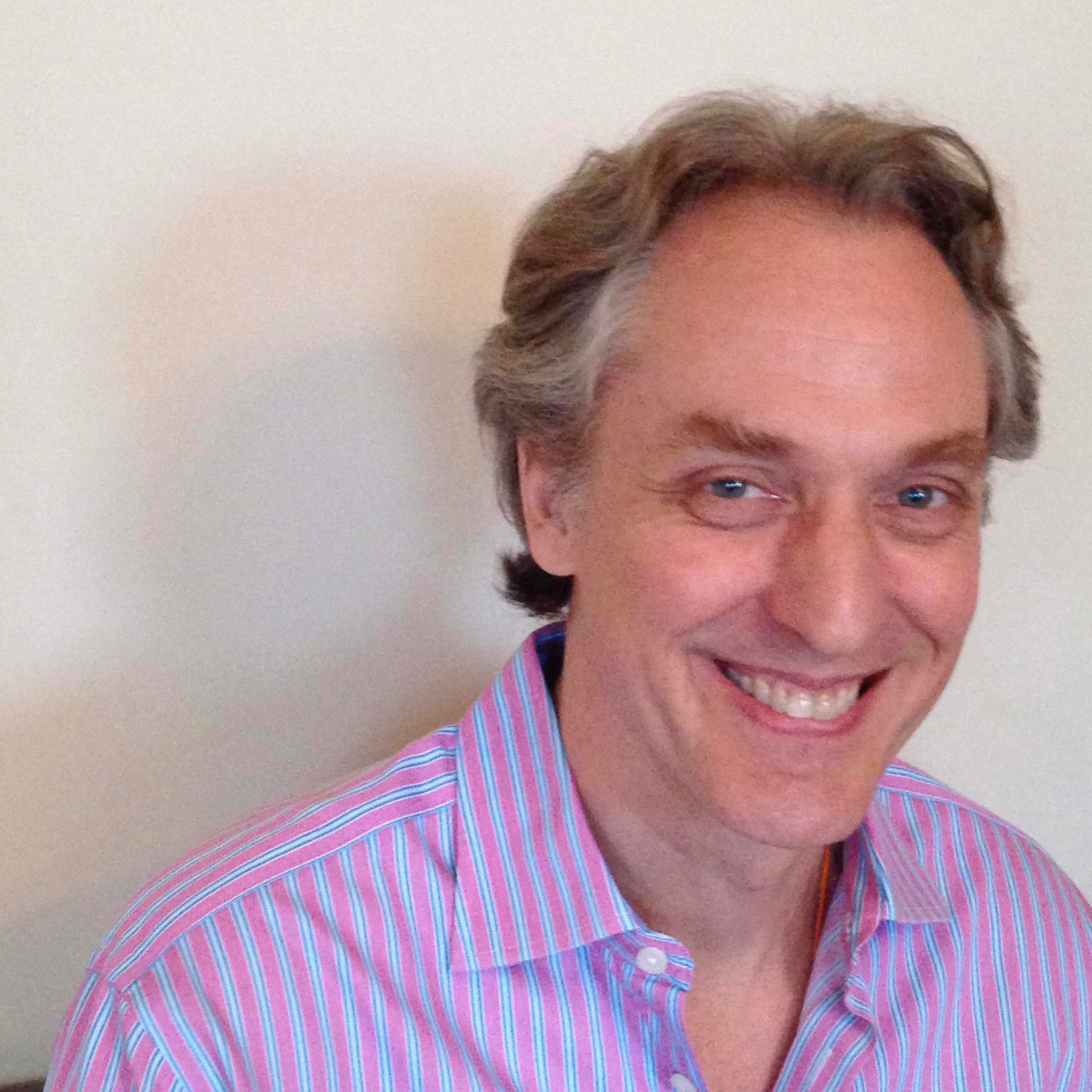 A smiling man in a striped shirt